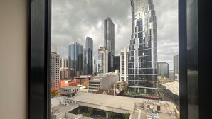 A cityscape with modern high-rise buildings, including a distinctive curved skyscraper.