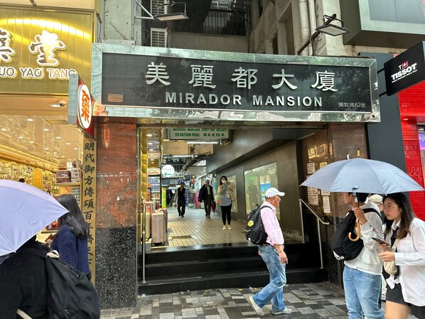 The exterior of Mirador Mansion with a sign indicating its name and address.