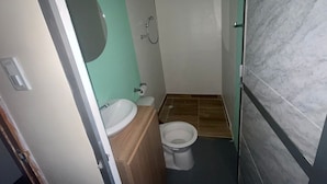 A small bathroom with a sink, toilet, and shower. - Miramar Baru (Cartagena)