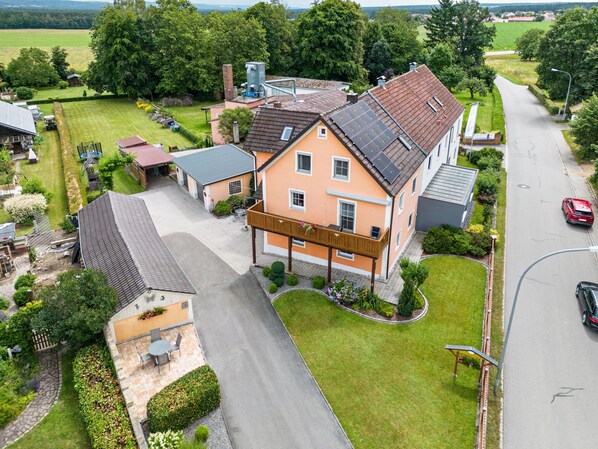 Ein Wohnhaus mit großem Garten, Garage und Auffahrt.
