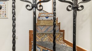 A staircase with ornate metal railings and patterned tile steps. - GuestHost - Modern Two-Levels Apartment with Balconies! (Palermo)