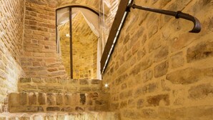 A stone staircase with a metal handrail and a small alcove with a white curtain. - The Monastery - Unique Vacation Home (Monteprandone)