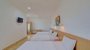 A hotel room with two beds, a TV, a painting, and a desk. - Hotel O Simalem Guest House (Kuta)