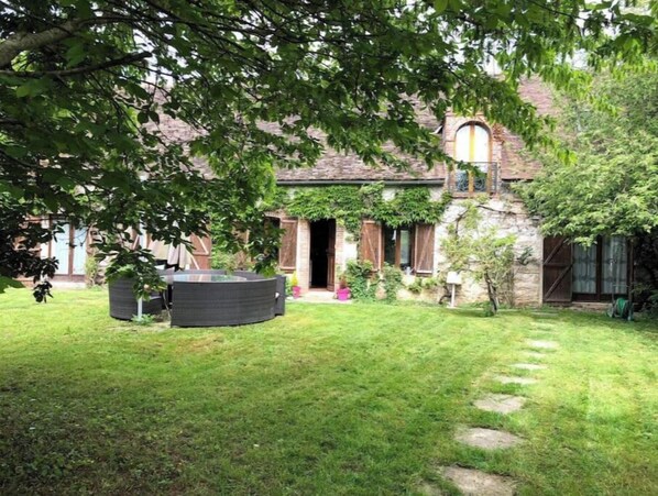 Escape to a serene country retreat surrounded by mature trees and a beautifully manicured lawn.