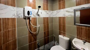 A bathroom with a shower, toilet, and sink.