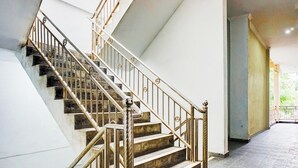 A staircase with metal railings and stone steps. - Super OYO Resident- K Syariah (Medan)