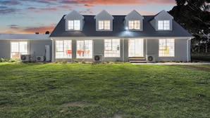 A modern house with a well-maintained lawn, large windows, and a clear sky. - Bulla Homestead  (Bulla)