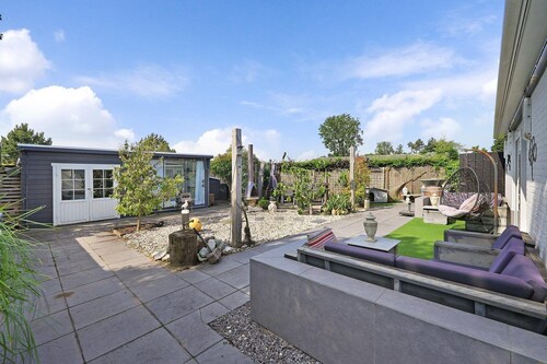 The charmingly furnished holiday home with luxurious amenities and a spacious private garden is located near the sea and dunes.