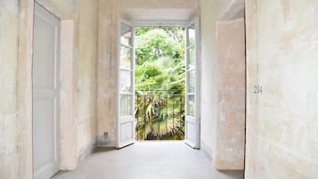 A narrow hallway with a white door on the left and a white wall on the right.