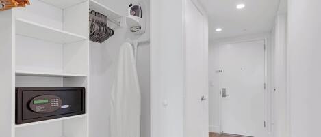 A hallway with a white closet, a security keypad, and a door.
