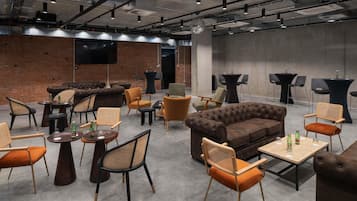 A spacious lounge area with multiple seating options including sofas, chairs, and tables.
