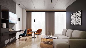 A modern living room with a sofa, chairs, a coffee table, and a TV. - Pullman Zagreb (Zagreb)