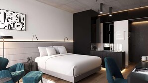 A modern hotel room with a large bed, two chairs, a desk, and a minibar. - Pullman Zagreb (Zagreb)