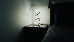 A bedside table with a ring light and a pair of scissors.