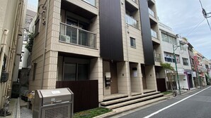 Ein mehrstöckiges Gebäude im modernen Stil, mit Balkonen und großen Fenstern.