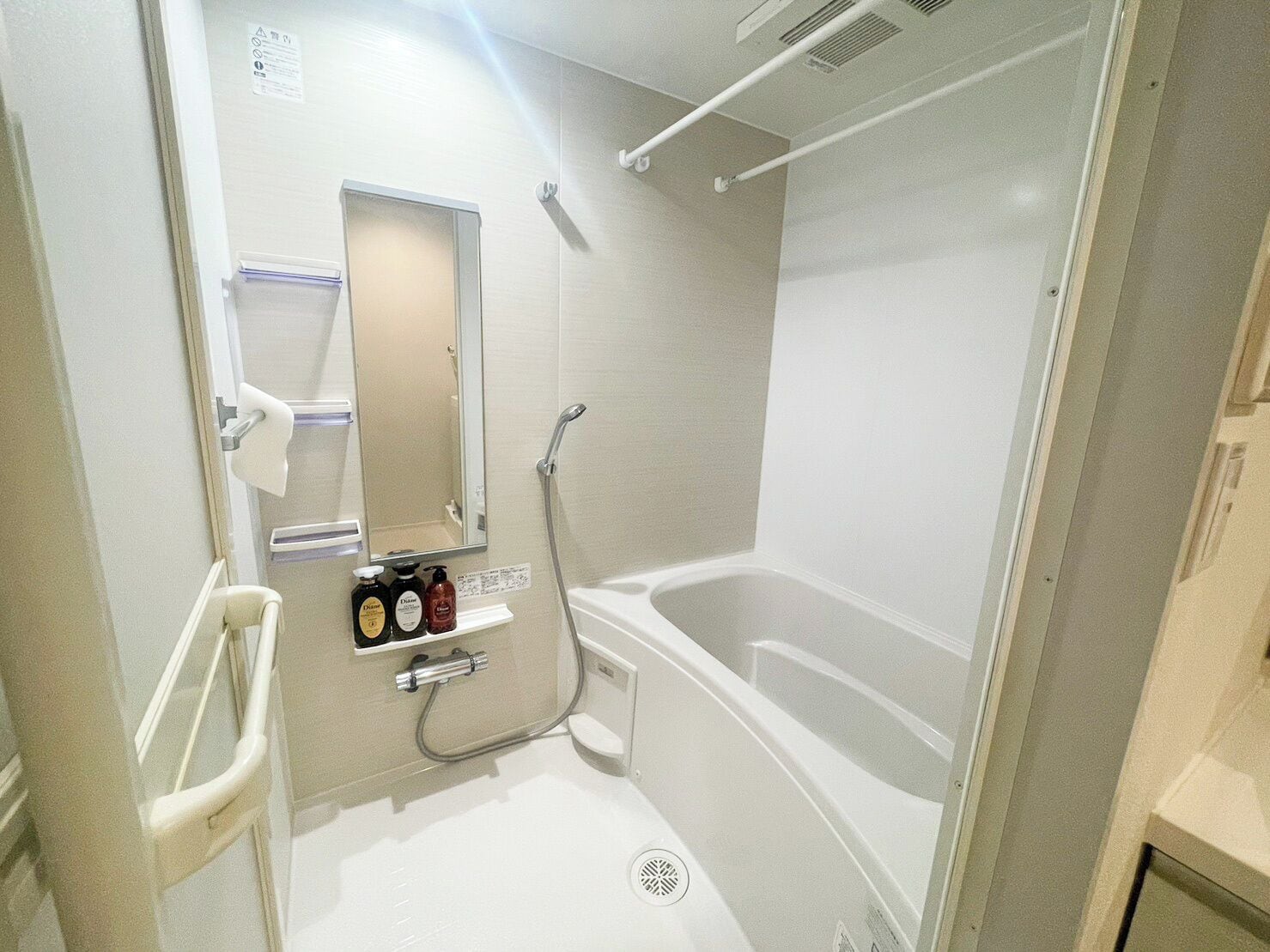 A small, modern bathroom with a walk-in shower, a toilet, and a sink.