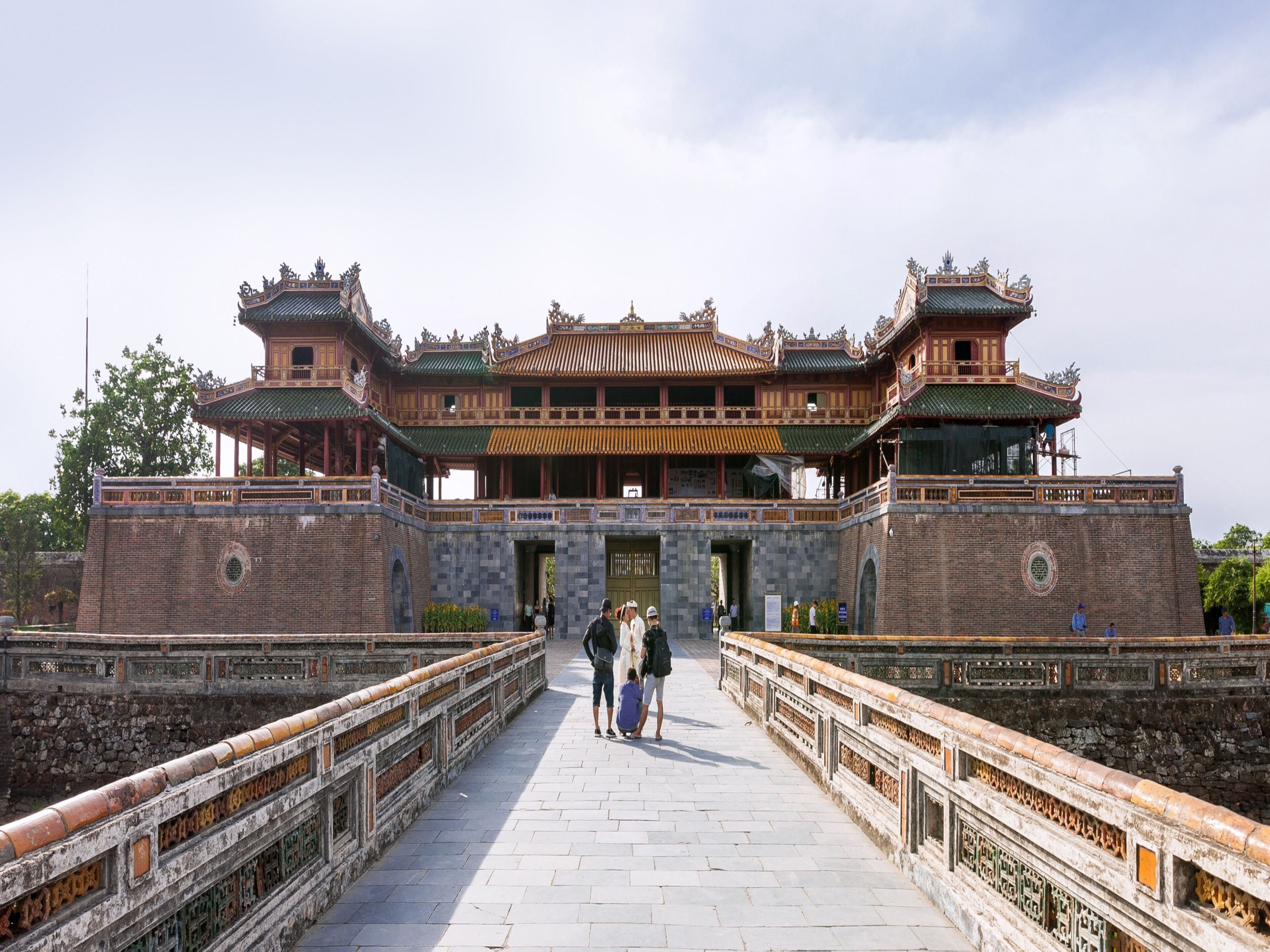 A traditional Chinese building with a symmetrical facade, a central entrance, and a tiled walkway leading to it.