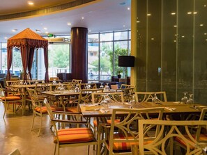 Enjoy dining and socializing in this inviting space with a variety of seating options and a striking canopy centerpiece.