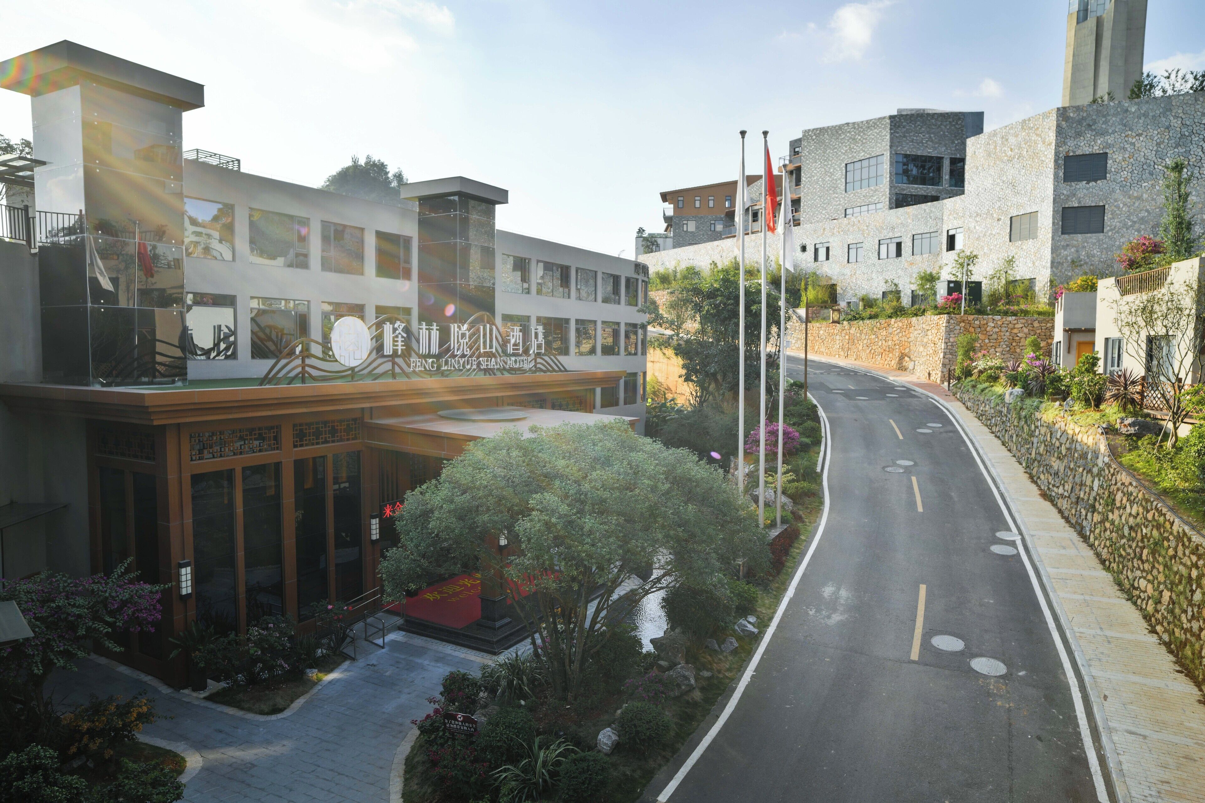 A modern building with a large entrance and a landscaped garden area.