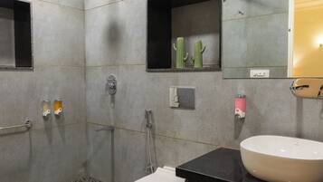 A bathroom with a shower, toilet, sink, and a ceiling fan.