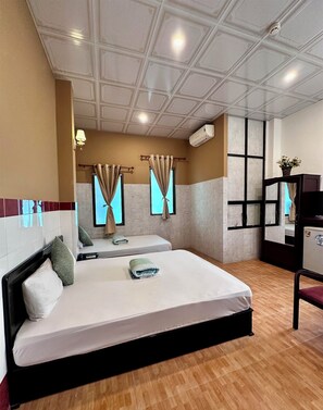 A hotel room with two beds, a wooden floor, a ceiling with recessed lighting, and an air conditioning unit. - Nam Đô Hotel Cần Thơ Downtown (Can Tho)