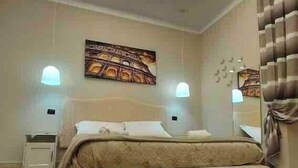 A bedroom with a bed, a ceiling light, and a wall-mounted artwork.