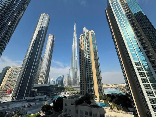 Un paysage urbain avec des immeubles modernes de grande hauteur, dont un gratte-ciel remarquable à l’architecture originale.