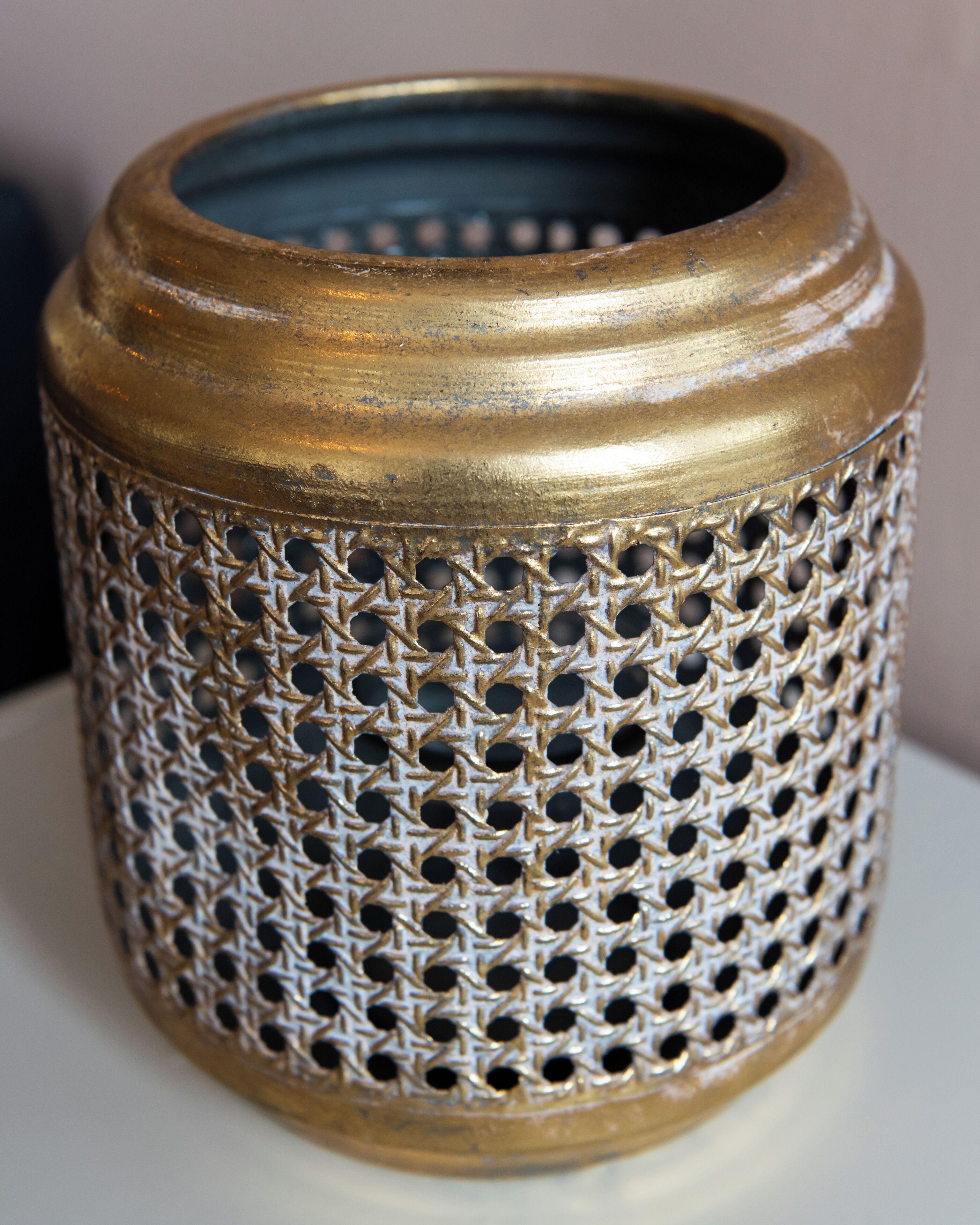 Un objet cylindrique doté d’une surface texturée et d’un motif perforé.