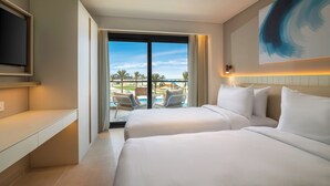 A hotel room with two beds, a TV, a balcony with a pool view, and a large abstract painting. - Palma Bay Rotana Resort (El Alamein)
