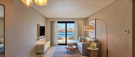 A modern hotel room with a balcony, a dining area, and a living space.