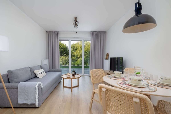 Elegant and welcoming living area with a cozy sofa and dining setup.