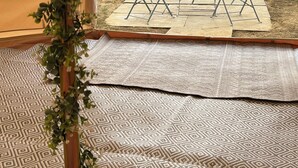 A tented room with a view of a grassy area and two chairs. - Luxury Bell Tents with beautiful views (Lower Boddington)