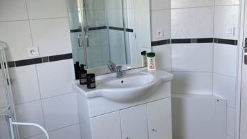 Shower, hair dryer, towels, toilet paper