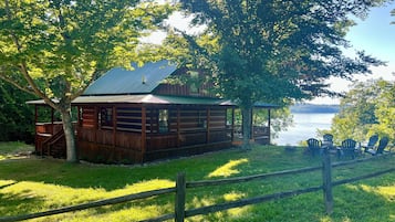 Relax on the covered porch or deck, surrounded by lush greenery and a serene water view.