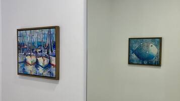 Two framed paintings on a wall.