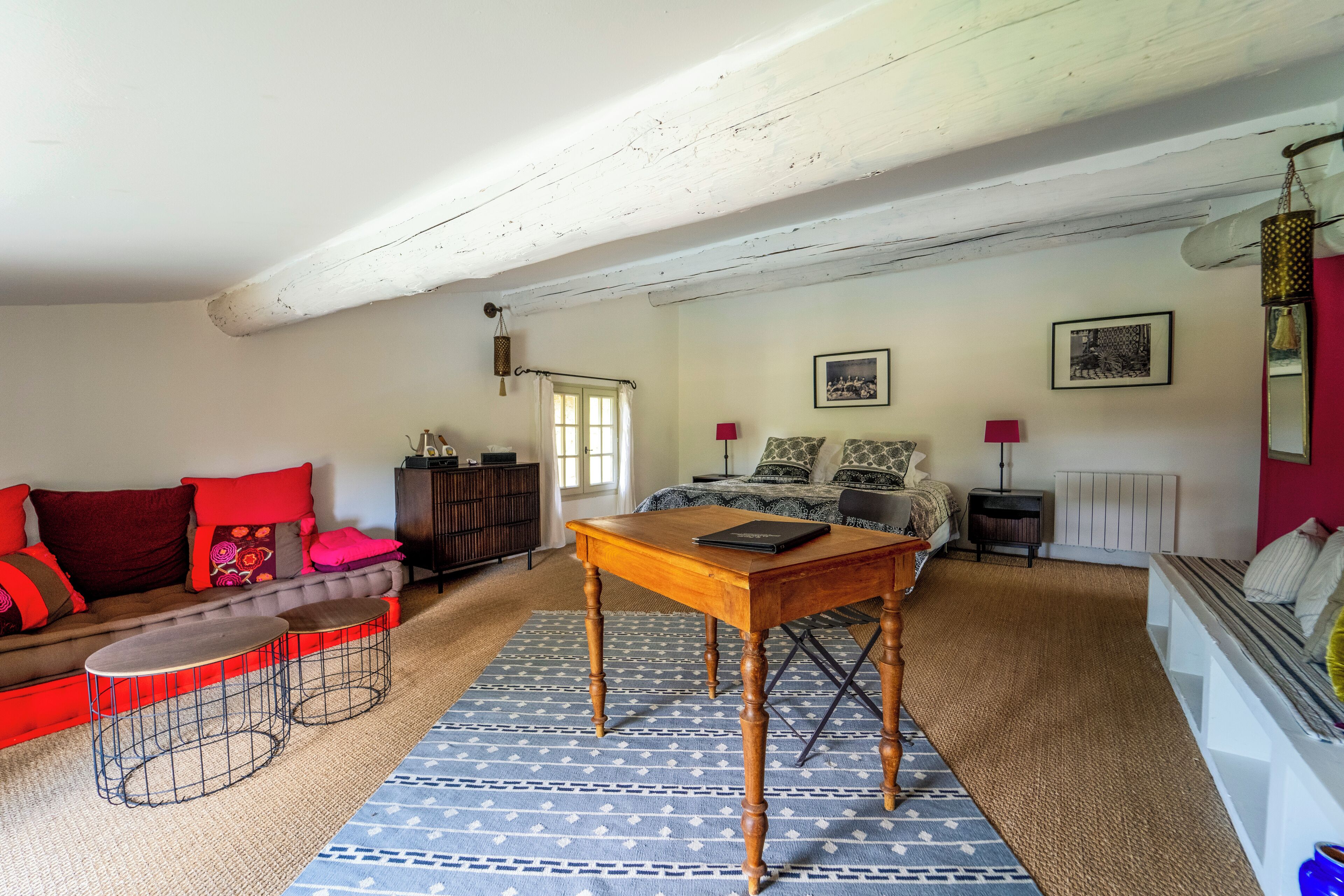 Un salon chaleureux avec un canapé, une table basse en bois et un tapis à motifs.