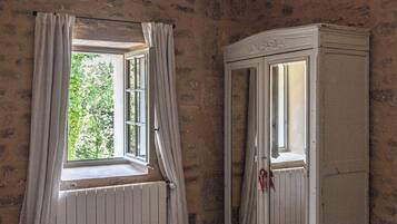 A room with a window and a white cabinet.