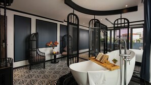 A modern bathroom with a freestanding bathtub, black metal decor, and patterned floor tiles. - Hanoi Le Chateau Hotel & Spa (Hanoi)