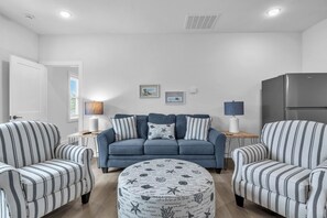 TV, fireplace, books - Trottin’ To Paradise: Charming, Spacious Rental with Private Pool (Oak Island)