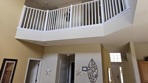 A corner room with a balcony, a star decoration, and a leaf pattern on the wall. - Spacious 7 Br, 4.5 Br Retreat With Pool 7 Bedroom Condo by RedAwning (Kissimmee)