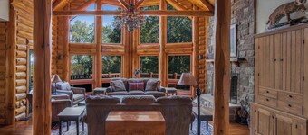 Secluded 4 bedroom log style home with screened porches, deck and fishing pond.