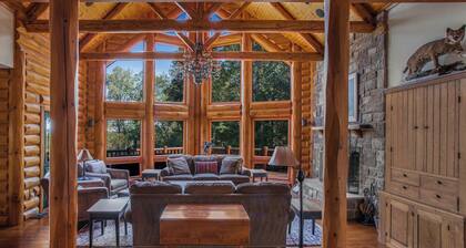Secluded 4 bedroom log style home with screened porches, deck and fishing pond.