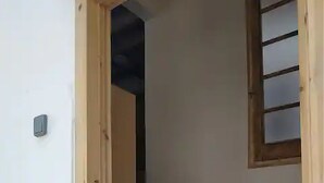 A staircase leading to a landing with a small window.