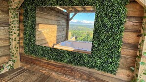 A wooden cabin with a built-in hot tub, surrounded by ivy and wooden beams. - Kennel House with Hill Views perfectly situated for walks. - 20 min to the beach (Whitland)