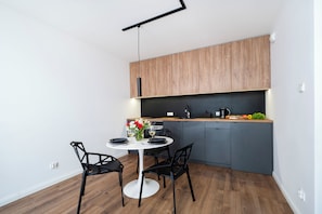 Enjoy meals in the kitchen and dining area, featuring a round table and four chairs.