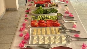A buffet table with various food items and utensils. - Gaya Pansiyon (Kemer)