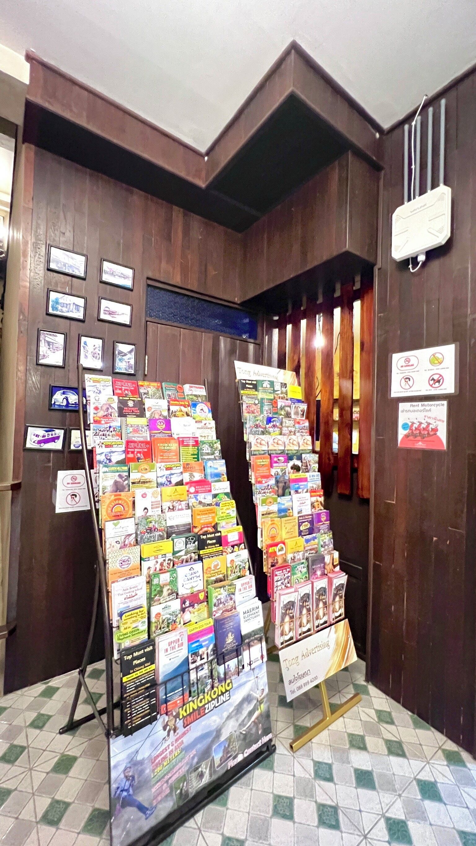 A travel information booth with various brochures and signs.