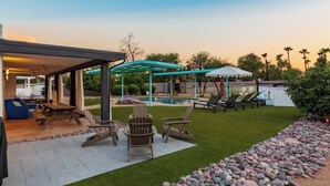 A backyard with a pool, outdoor seating, and a covered patio area. - HUGE YARD + Pool|Billiards|PingPong|Putting Green (Scottsdale)