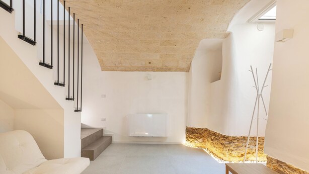 En modern inredning med en trappa, en vit soffa och en minimalistisk design.