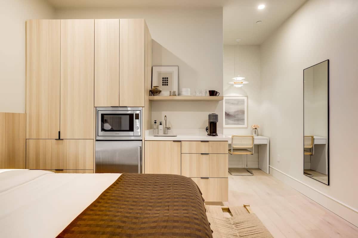 Relax in a spacious room with a large bed, microwave, and coffee maker.